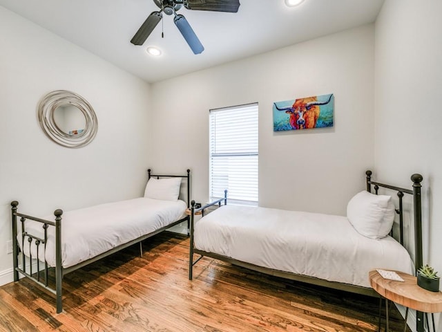 bedroom featuring ceiling fan, wood finished floors, and recessed lighting