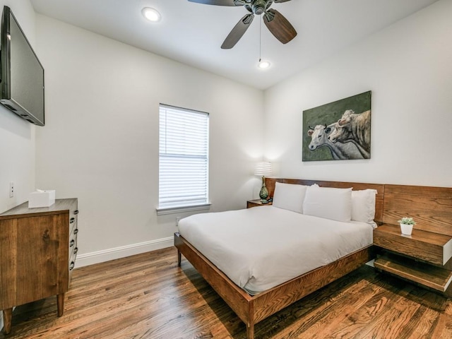 bedroom featuring a ceiling fan, recessed lighting, baseboards, and wood finished floors