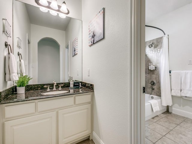 full bathroom featuring tile patterned flooring, baseboards, tub / shower combination, and vanity