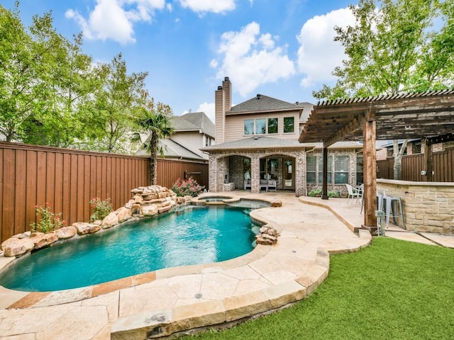 view of pool featuring outdoor dry bar, a pool with connected hot tub, a patio area, a pergola, and a fenced backyard