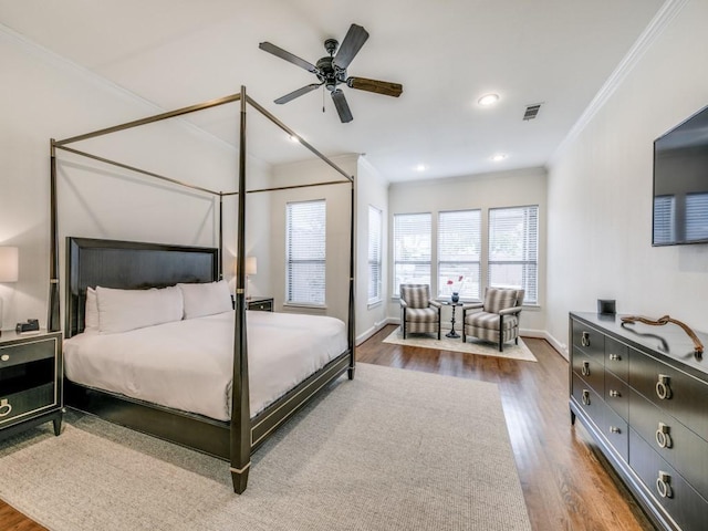 bedroom featuring recessed lighting, visible vents, ornamental molding, wood finished floors, and baseboards