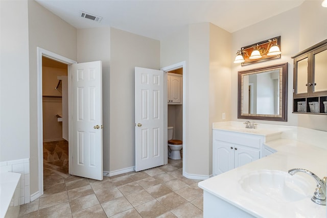 full bathroom with toilet, vanity, baseboards, visible vents, and tile patterned floors