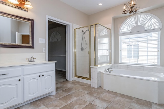 full bathroom featuring a garden tub, tile patterned flooring, an inviting chandelier, vanity, and a shower stall