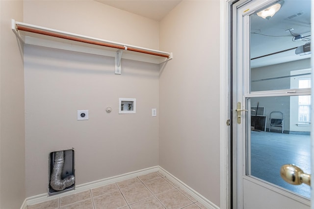 laundry room featuring laundry area, baseboards, hookup for an electric dryer, washer hookup, and light tile patterned flooring