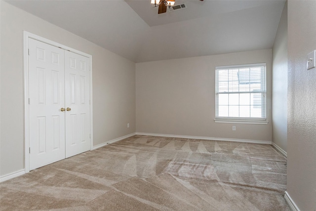 interior space with a closet, visible vents, a ceiling fan, carpet flooring, and baseboards