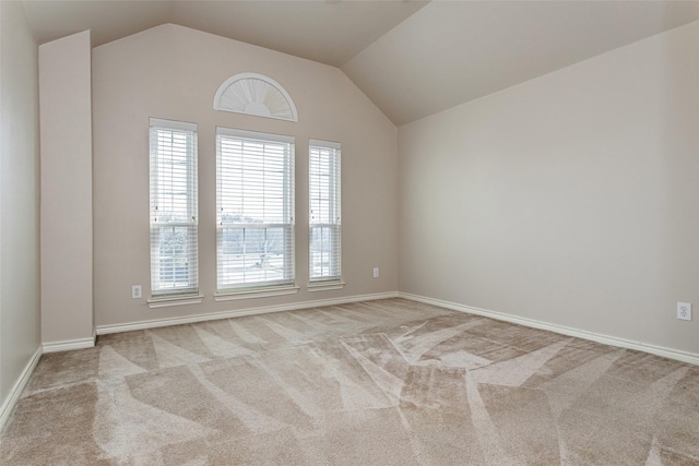 empty room featuring lofted ceiling and light colored carpet