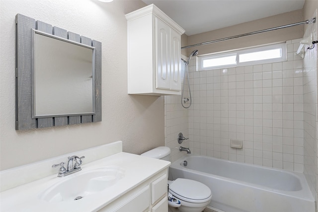 bathroom with a textured wall,  shower combination, vanity, and toilet