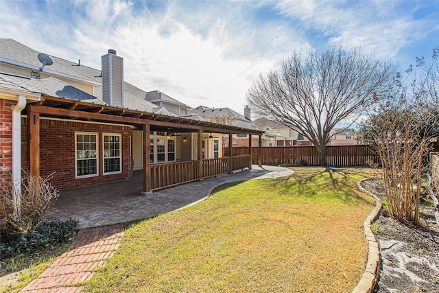 view of yard featuring ceiling fan, a patio, and a fenced backyard