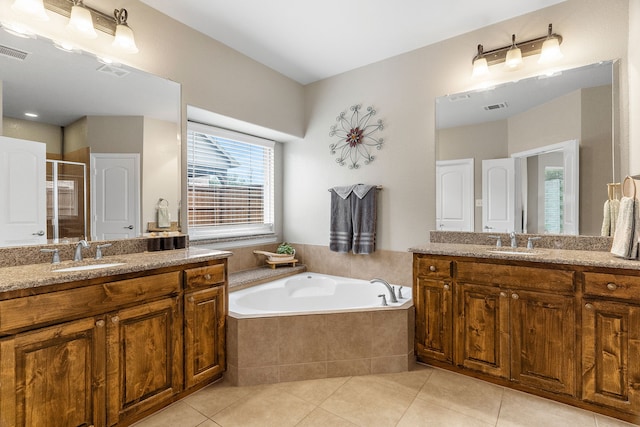 bathroom featuring visible vents, a sink, a shower stall, and tile patterned floors