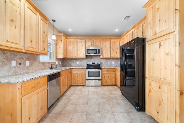 kitchen with stainless steel appliances, a sink, visible vents, backsplash, and light brown cabinetry