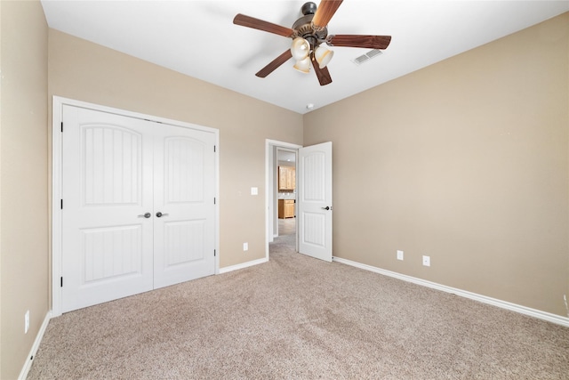 unfurnished bedroom with light carpet, a closet, visible vents, and baseboards