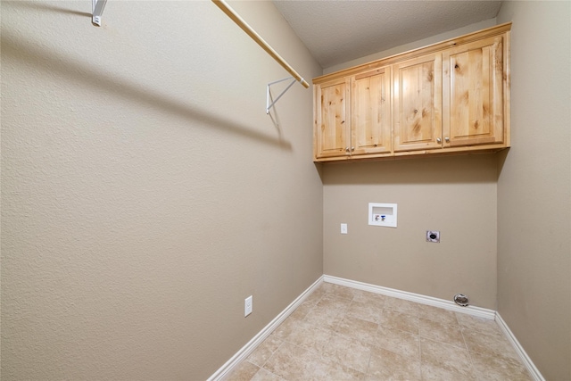 washroom featuring cabinet space, baseboards, hookup for a washing machine, hookup for an electric dryer, and light tile patterned flooring