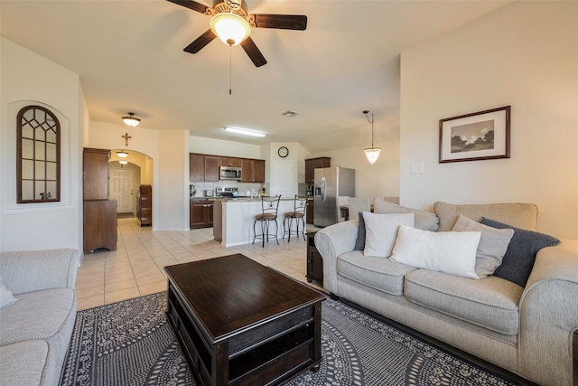 2278 Bryant Ln, Fate, TX 75189 - living area with ceiling fan, light tile patterned floors, and arched walkways