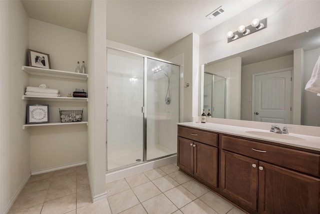 2278 Bryant Ln, Fate, TX 75189 - bathroom with tile patterned floors, a stall shower, vanity, and baseboards