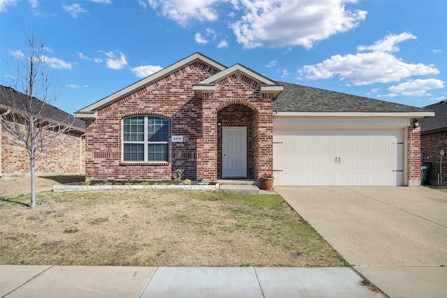 2278 Bryant Ln, Fate, TX 75189 - view of front of house featuring brick siding, a garage, driveway, and a front yard