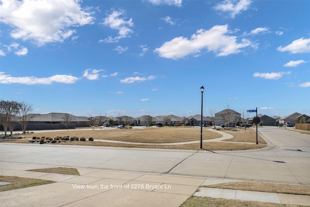 2278 Bryant Ln, Fate, TX 75189 - view of concrete street with sidewalks, a residential view, curbs, and street lighting