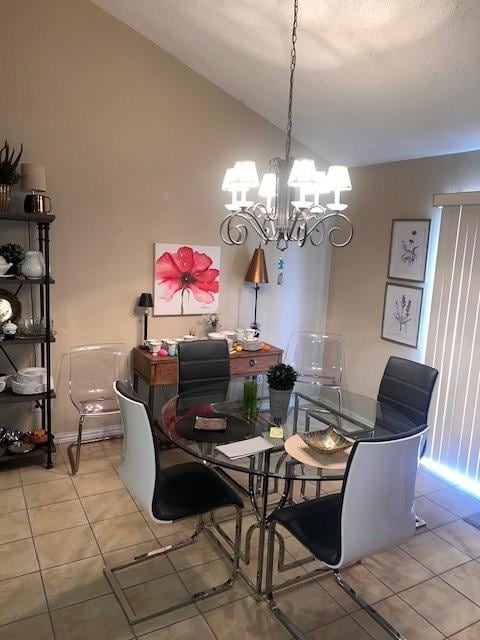 tiled dining room with vaulted ceiling and a notable chandelier