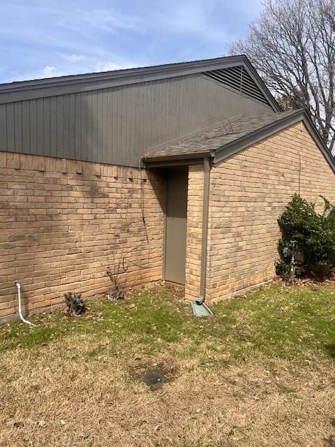 view of property exterior with brick siding