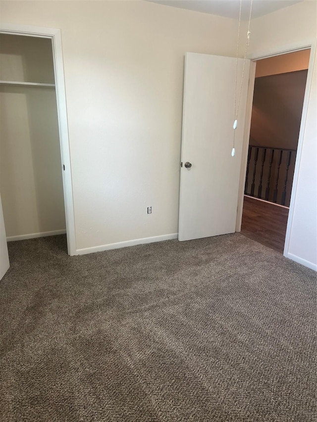 unfurnished bedroom featuring carpet flooring and baseboards