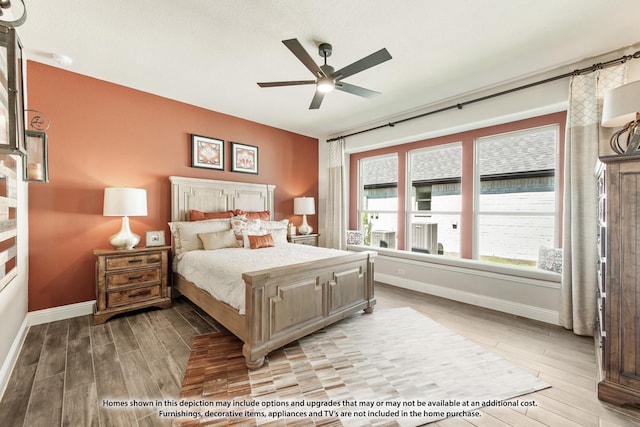 bedroom featuring light wood finished floors, a ceiling fan, and baseboards