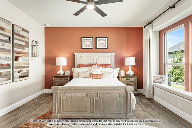 bedroom with baseboards, ceiling fan, multiple windows, and wood tiled floor