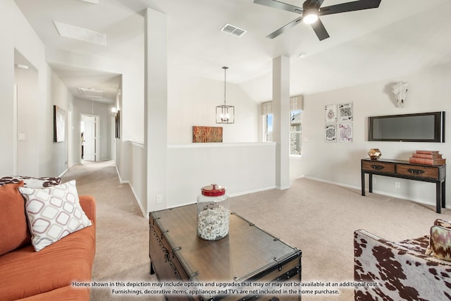 living room featuring attic access, visible vents, vaulted ceiling, and carpet flooring