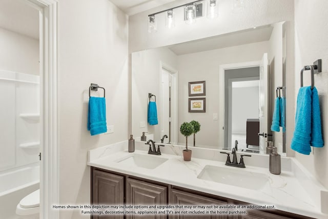 bathroom featuring a sink and double vanity