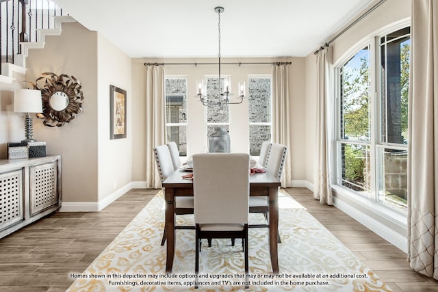 dining area featuring plenty of natural light, baseboards, and wood finished floors