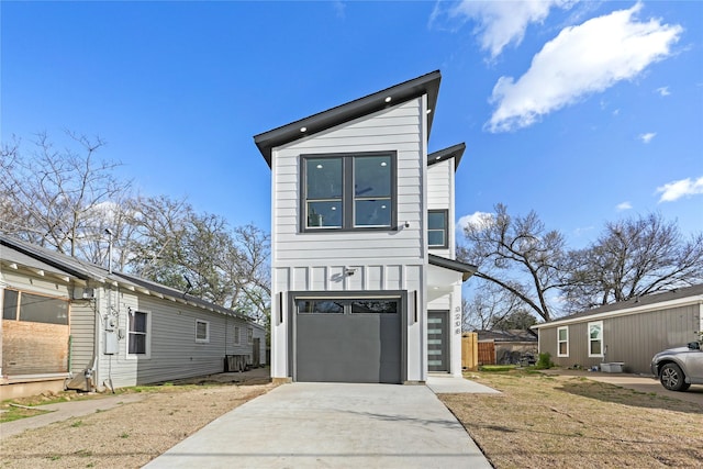 view of front of house featuring a garage, concrete driveway, central AC unit, and board and batten siding