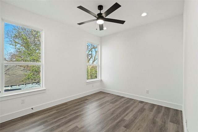 spare room featuring dark wood-style flooring, recessed lighting, a ceiling fan, and baseboards