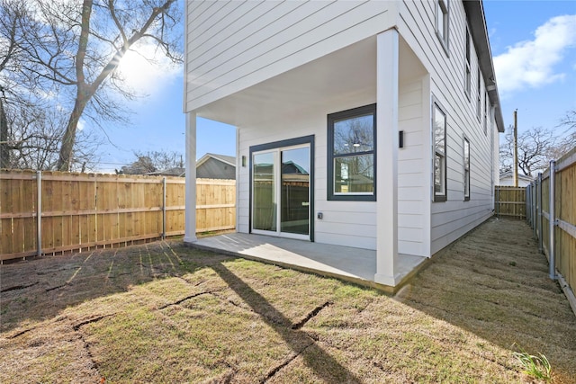 rear view of property with a patio area, a fenced backyard, and a lawn