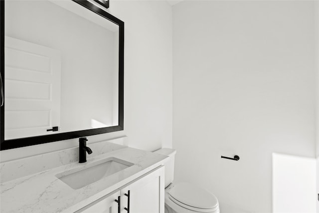 bathroom with toilet and vanity