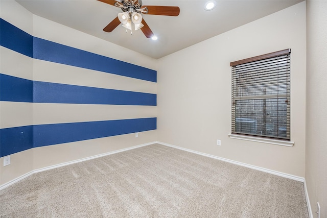 carpeted spare room with ceiling fan, baseboards, and recessed lighting