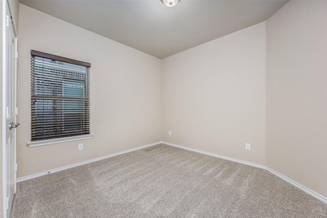 carpeted empty room with baseboards