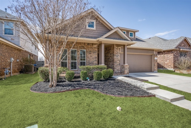 craftsman-style house with driveway, brick siding, a front lawn, and an attached garage