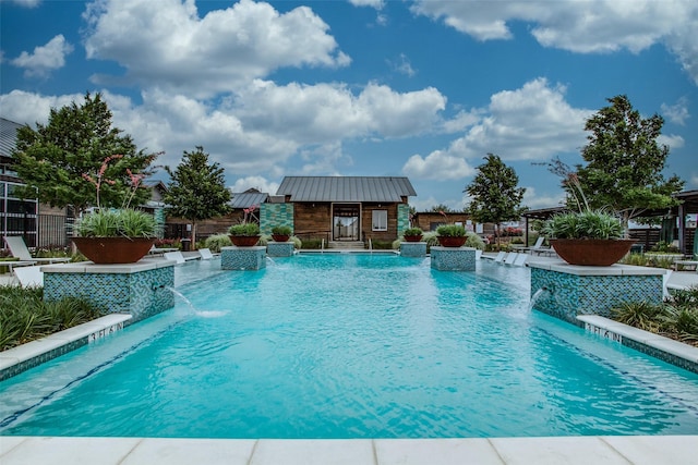 community pool featuring a storage structure, a patio area, fence, and an outdoor structure