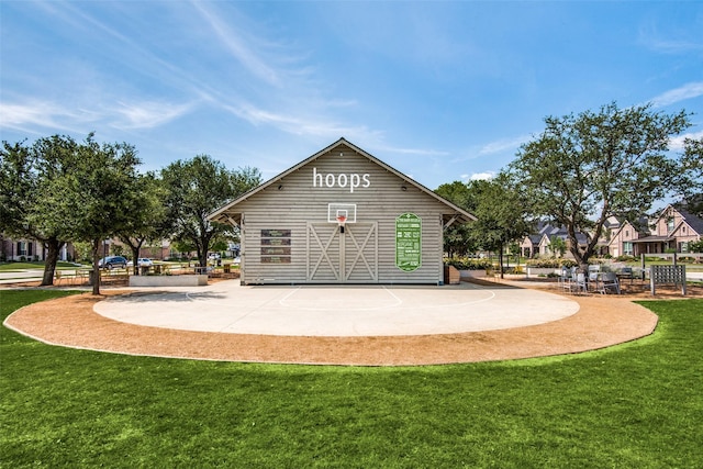 view of community featuring basketball court and a lawn