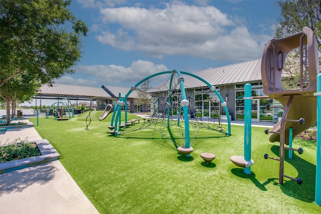 community jungle gym featuring a lawn