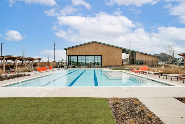 pool featuring a patio, a lawn, and fence