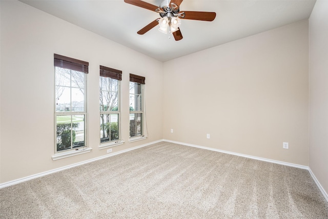 empty room featuring carpet floors, baseboards, and a ceiling fan