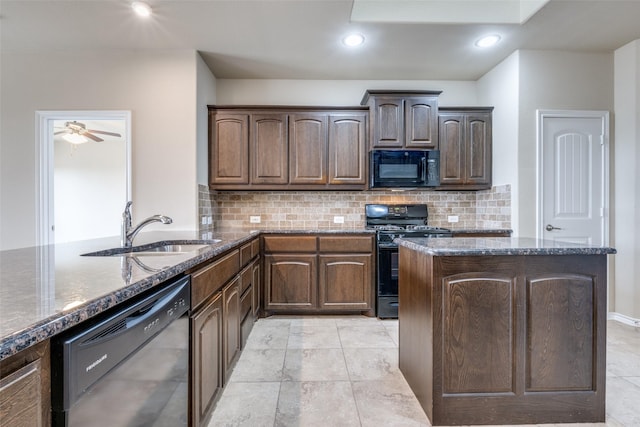 kitchen featuring decorative backsplash, dark stone counters, a sink, and black appliances