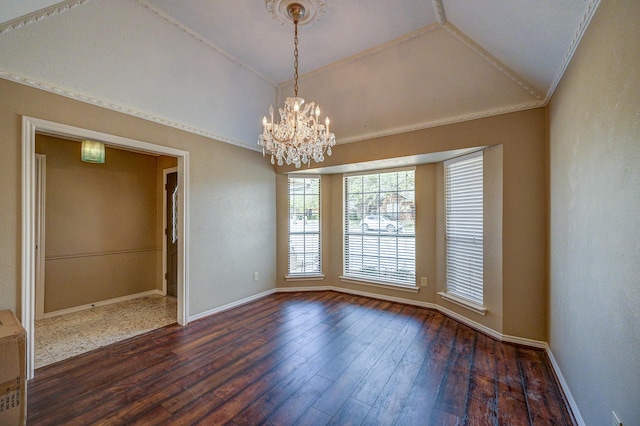 spare room with dark wood finished floors, an inviting chandelier, baseboards, and lofted ceiling