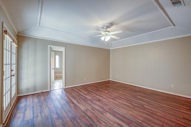 empty room featuring visible vents, crown molding, baseboards, and dark wood-style flooring