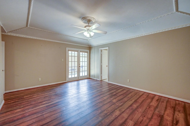 spare room featuring a ceiling fan, crown molding, wood finished floors, and baseboards