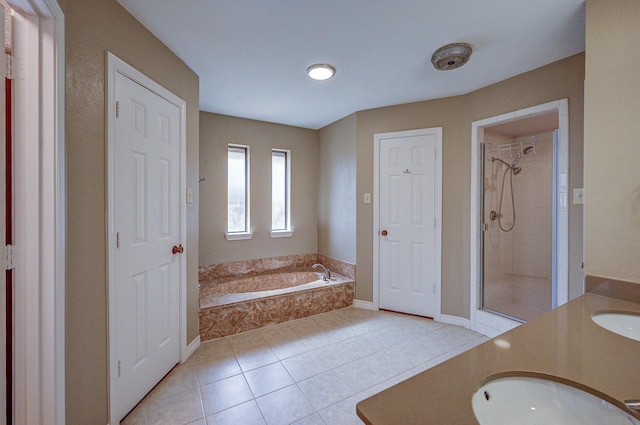 full bath featuring a bath, tile patterned floors, a stall shower, and vanity