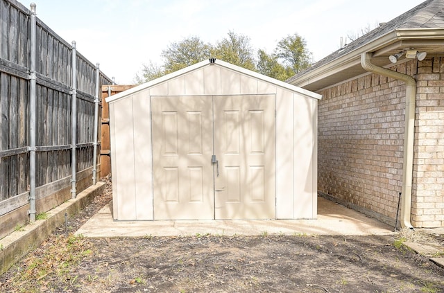 view of shed with fence