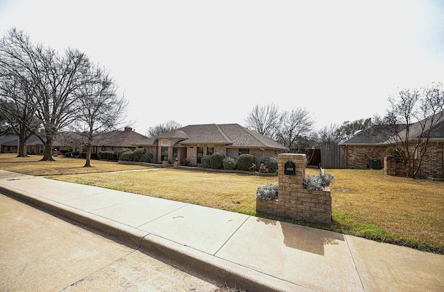 view of front of house featuring a front yard and fence