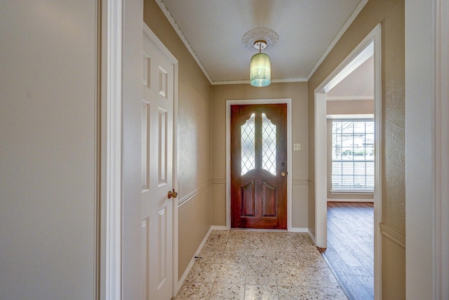 foyer featuring light floors, crown molding, and baseboards