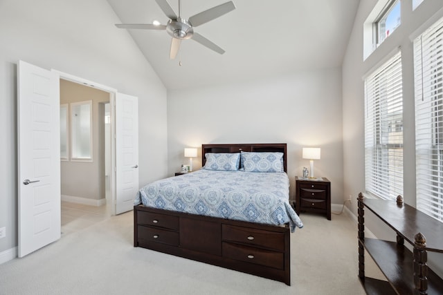 bedroom with baseboards, high vaulted ceiling, a ceiling fan, and light colored carpet