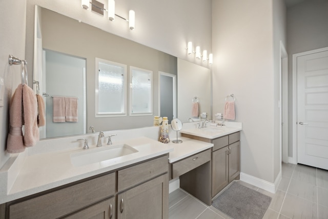 full bathroom with tile patterned floors, baseboards, and vanity